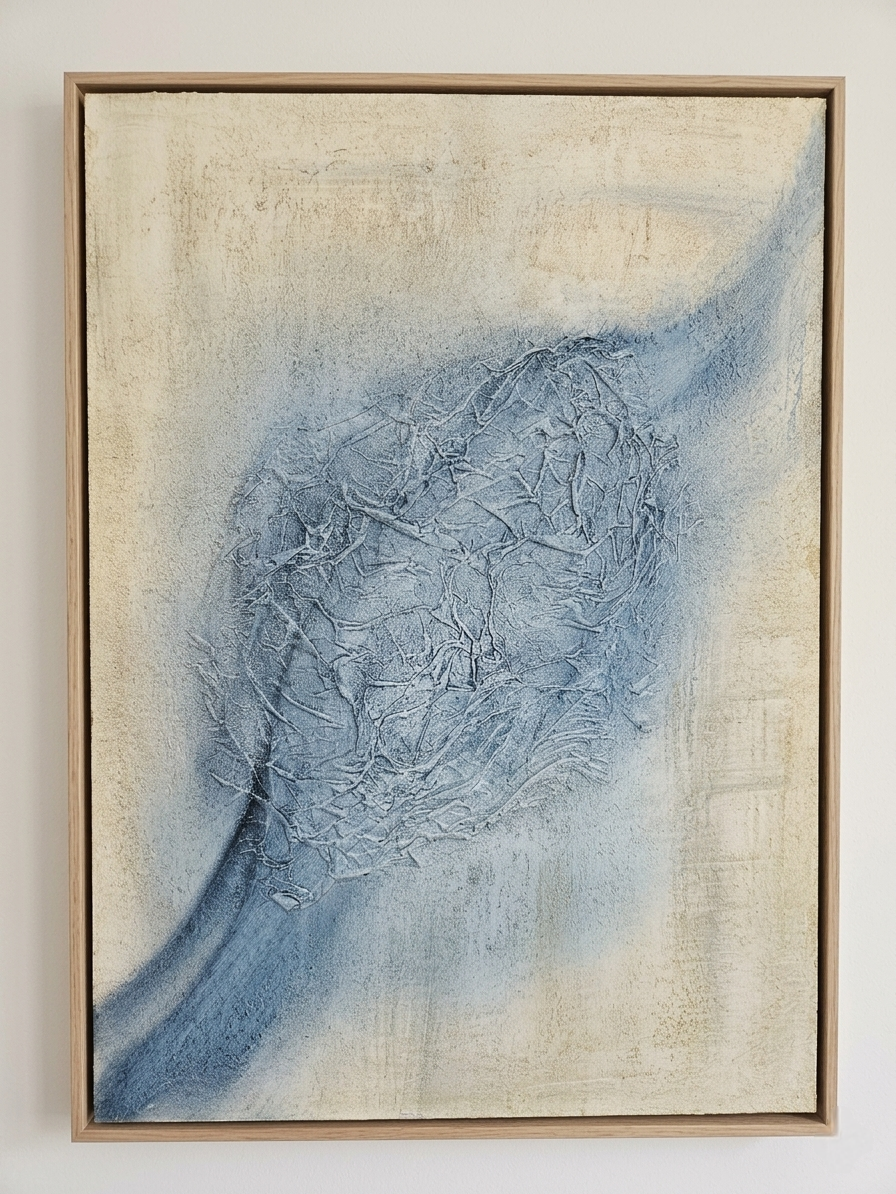 Luda Art Space — "Soul of Indigo" mixed media textured painting. An organic, sculptural relief of woven and intertwined natural fibers forms a large, neural-like indigo-blue node against a neutral, beige and sand-colored plaster-effect canvas. An intricate flow line of deeper blue extends from this central abstract cluster, creating a dynamic diagonal movement. The art is presented in a modern, light oak floater frame. The textural elements, including fine fiber detail and a layered background, are a tactile exploration in abstract expressionism. Size: 50x70cm.