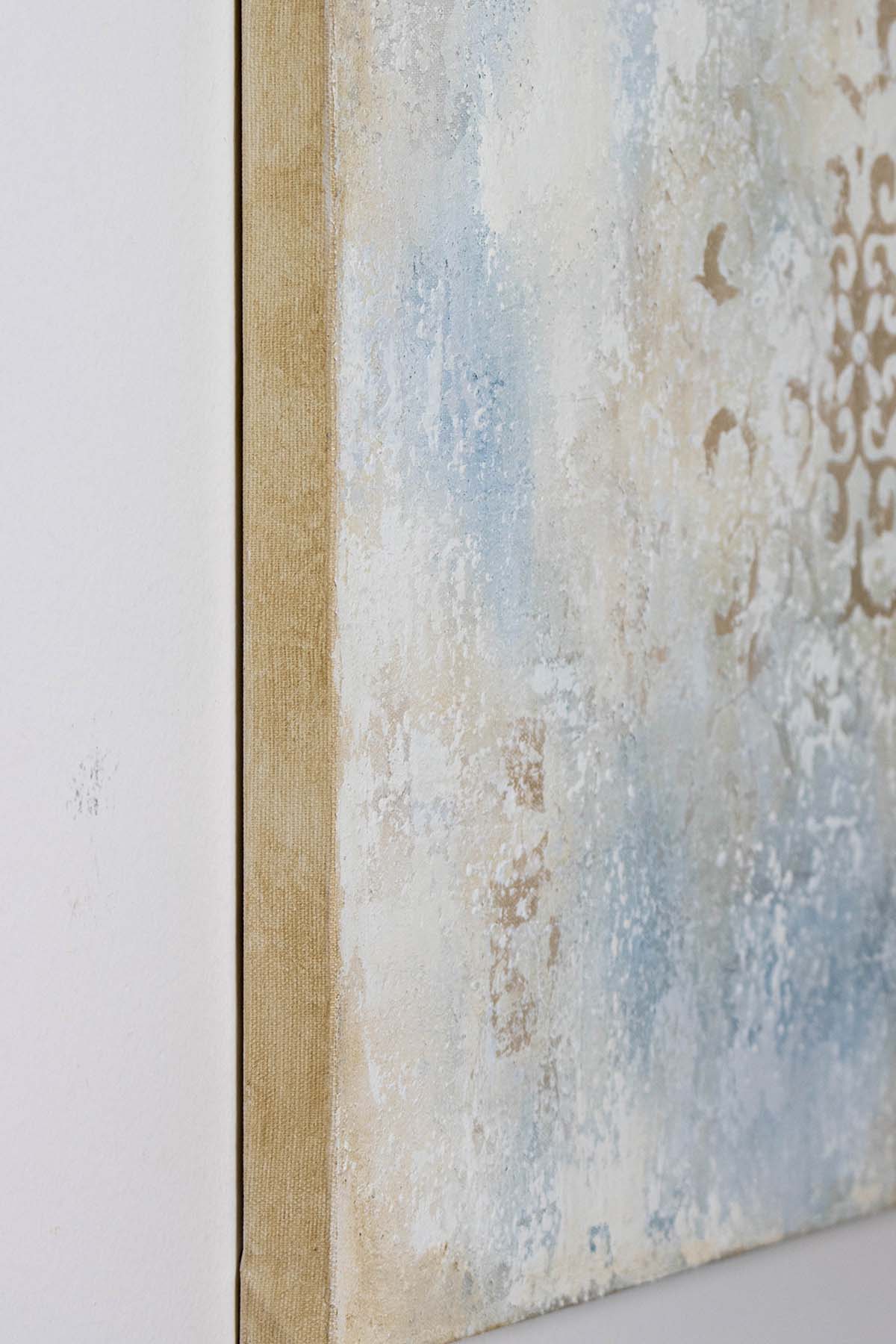 Side view of Between Echoes I showing the raised textured surface, layered relief and subtle metallic details in a soft neutral palette.